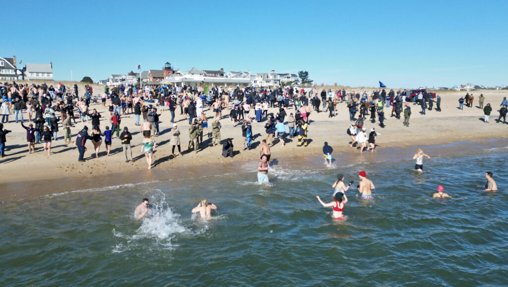 A crowd of people swimming in the water.